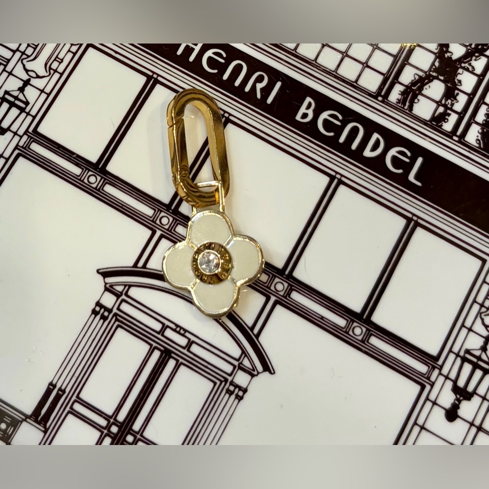 NWOT HENRI BENDEL Gold/White Flower Charm with Crystal. Each side is the same.
